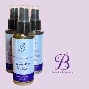 Three bath bomb beauties body mist spray bottles with blue labels on a lavender background logo reads bath bomb beauties