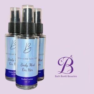 Three blue labeled bath bomb beauties body mist spray bottles on a lavender background ombre leather for her