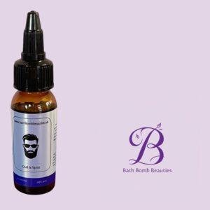 Small amber dropper bottle with black cap and label reading oud  spice beside bath bomb beauties logo on a lavender background