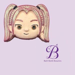 Partial image of a pink haired dolls face against a lavender background with the bath bomb beauties logo visible to the right