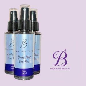 Three bath bomb beauties spray bottles body mist for her arranged against a light purple background with the brands purple logo visible to the right