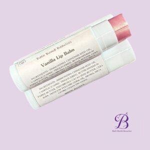Lip balm labeled vanilla lip balm on a pastel lavender background
