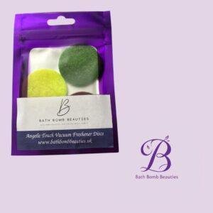 Purple resealable pouch with colorful vacuum freshener discs (yellow, green) and Bath Bomb Beauties logo on a light purple background; includes website text on label: bathbombbeauties.uk