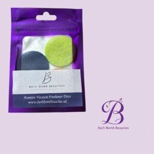 Purple resealable bag containing lime green and dark bath discs; label reads Bath Bomb Beauties and www.bathbombbeauties.uk.