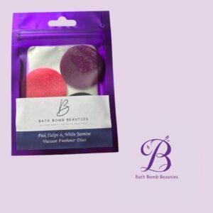 Purple resealable pouch with pink and purple bath discs; label reads 'Pink Tulips & White Jasmine Vacuum Freshener Discs' (Bath Bomb Beauties).
