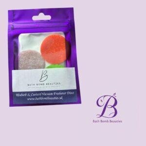Purple resealable pouch with three colorful discs visible inside, Bath Bomb Beauties branding on a lavender background.