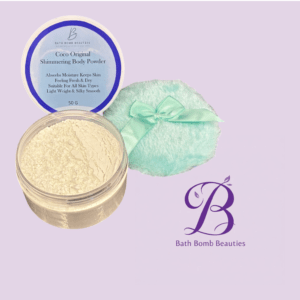 Coco original shimmering body powder jar open on a lavender background with a mint cloth and bath bomb beauties logo visible
