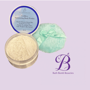 Container of goddess shimmering body powder with loose powder spilled beside a pastel mint cloth and ribbon on a lavender background bath bomb beauties branding visible