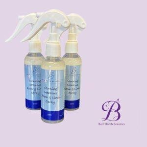 Triple set of bath bomb beauties morning meadows room  linen spray bottles against a lavender background with logo visible