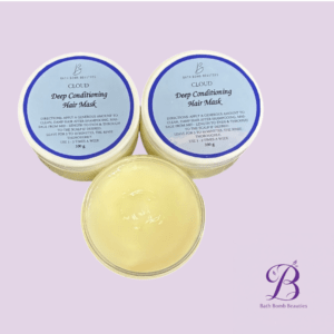 Two blue-lidded containers labeled 'Cloud Deep Conditioning Hair Mask' with an open pale yellow jar on a lavender background, plus Bath Bomb Beauties logo in the corner.