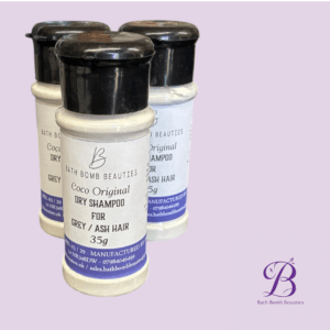 Three small bath bomb beauties coco original dry shampoo bottles for greyash hair on a lavender background with the bath bomb beauties logo in the bottom right