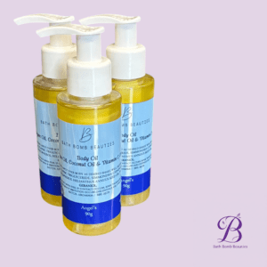 Three white-pump bottles containing yellow body oil sit against a lavender background; Bath Bomb Beauties logo appears bottom right.