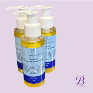 Three Pump-top bottles labeled Bath Bomb Beauties Body Oil with coconut oil & vitamin C, on a lavender background; logo in the bottom-right corner.