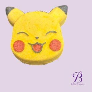 Close up of a yellow emoji face with heart shaped eyes and cat ears on a lavender background bath bomb beauties logo visible