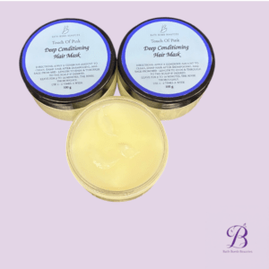 Two jars of Touch Of Pink Deep Conditioning Hair Mask with pale yellow product in an open container on a lavender background; Bath Bomb Beauties logo bottom right.